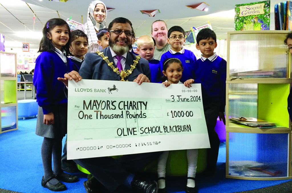Children from the Olive Primary School present Blackburn Mayor Salim Mulla with a cheque for £1000 on June 3